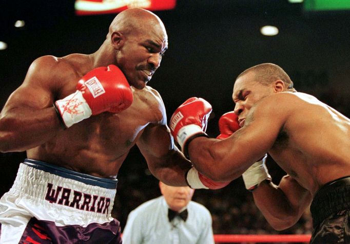 FILE PHOTO: WBA Heavyweight Champion Evander Holyfield (R) connects to the jaw of challenger Mike Tyson in the first round of their title fight June 28.  Evander Holyfied