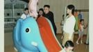 North Korean leader Kim Jong-un watches children playing on a slide, as an unidentified woman stands near him, during a visit to a pre-school in Pyongyang in this undated still image aired on video. REUTERS/KRT via Reuters TV (NORTH KOREA - Tags: POLITICS) FOR EDITORIAL USE ONLY. NOT FOR SALE FOR MARKETING OR ADVERTISING CAMPAIGNS. THIS IMAGE HAS BEEN SUPPLIED BY A THIRD PARTY. IT IS DISTRIBUTED, EXACTLY AS RECEIVED BY REUTERS, AS A SERVICE TO CLIENTS. NORTH KOREA OUT. NO COMMERCIAL OR EDITORIAL SALES IN NORTH KOREA Published: Čec. 15, 2012, 5:54 dop.