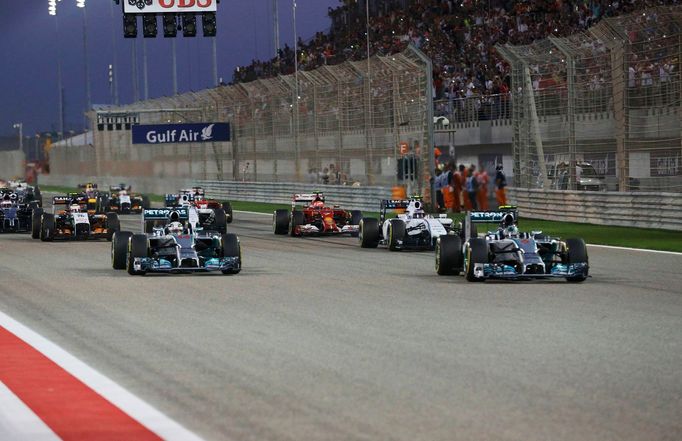 Mercedes Formula One driver Nico Rosberg of Germany (R) leads the pack at the start of the Bahrain F1 Grand Prix at the Bahrain International Circuit (BIC) in Sakhir, sou