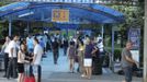 Passengers wait outside Bulgaria's Burgas airport July 18, 2012. An explosion which killed six people and injured dozens of Israeli tourists at the Bulgarian airport of Burgas was caused by a bomb in their bus, Bulgarian Foreign Minister Nikolai Mladenov told Reuters by telephone. In a statement, the foreign ministry said five people were killed and one died later in hospital. Thirty two people were taken to hospital with injuries. REUTERS/Nikolay Doncev (BULGARIA - Tags: DISASTER TRANSPORT)