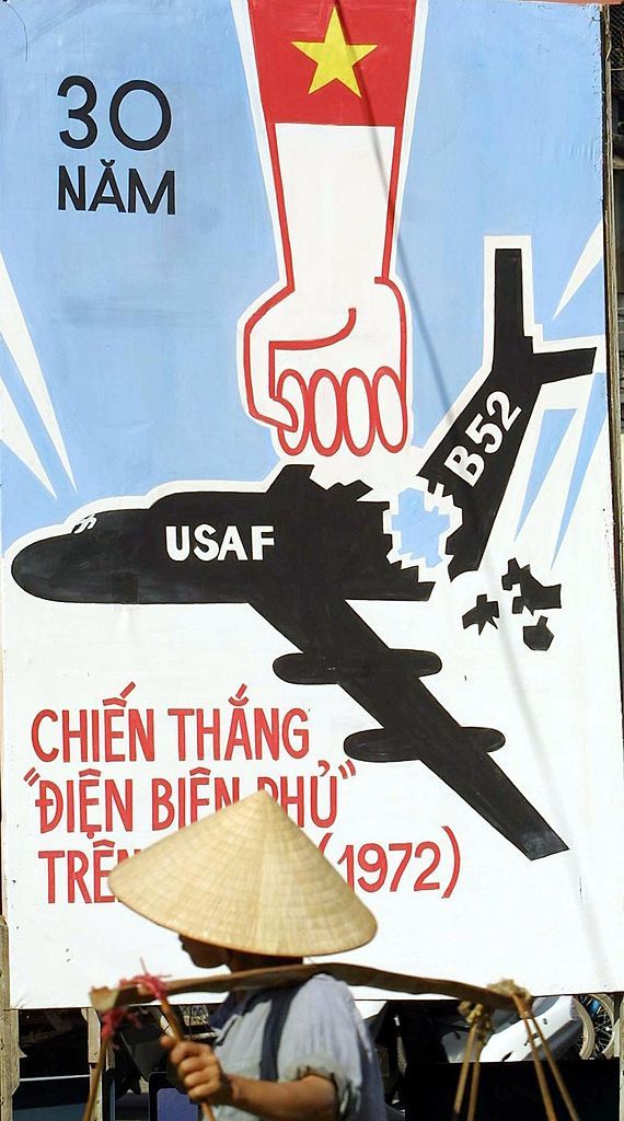 A Hanoi street vendor walks past a poster depicting the Vietnamese victory over US Airforce B52 massive bombing campaign launched against the Vietnamese capital in December 1972 on 18 December 2002. Vietnam is celebrating this week the 30th anniversary of the event which was qualified by Hanoi a "Dien Bien Phu in the air" with, according to Hanoi, almost 100 USAF aircrafts were shot down, including more than 30 strategic bombaders B52.