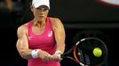 Samantha Stosur of Australia hits a return to Tsvetana Pironkova of Bulgaria during their women's singles match at the Australian Open 2014 tennis tournament in Melbourne