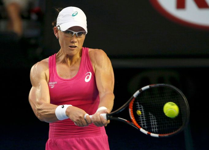 Samantha Stosur of Australia hits a return to Tsvetana Pironkova of Bulgaria during their women's singles match at the Australian Open 2014 tennis tournament in Melbourne