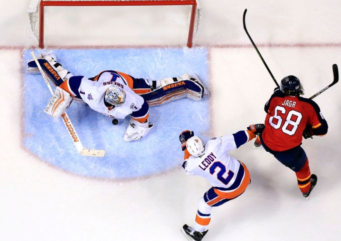 New York Islanders goalie Thomas Greiss (1) makes a save on a shot by Florida Panthers right wing Jaromir Jagr (68) as defenseman Nick Leddy (2) defend