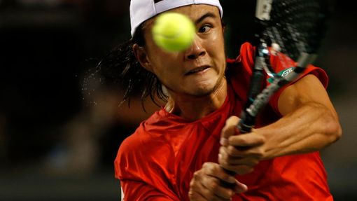 Japan's Daniel returns a shot against Czech Republic's Rosol during Davis Cup quarter-final tennis match in Tokyo
