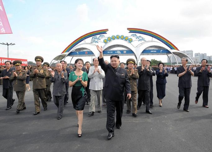 North Korean leader Kim Jong-Un (centre R) and his wife Ri Sol-Ju (centre L) attend the opening ceremony of the Rungna People's Pleasure Ground on Rungna Islet along the Taedong River in Pyongyang in this July 25, 2012 photograph released by the North's KCNA to Reuters on July 26, 2012.The Rungna People's Pleasure Ground has attractions such as a dolphinarium, a wading pool, a fun fair and a mini golf course, according to KCNA. REUTERS/KCNA (NORTH KOREA - Tags: POLITICS SOCIETY) FOR EDITORIAL USE ONLY. NOT FOR SALE FOR MARKETING OR ADVERTISING CAMPAIGNS. THIS IMAGE HAS BEEN SUPPLIED BY A THIRD PARTY. IT IS DISTRIBUTED, EXACTLY AS RECEIVED BY REUTERS, AS A SERVICE TO CLIENTS. NO THIRD PARTY SALES. NOT FOR USE BY REUTERS THIRD PARTY DISTRIBUTORS Published: Čec. 26, 2012, 3:22 dop.