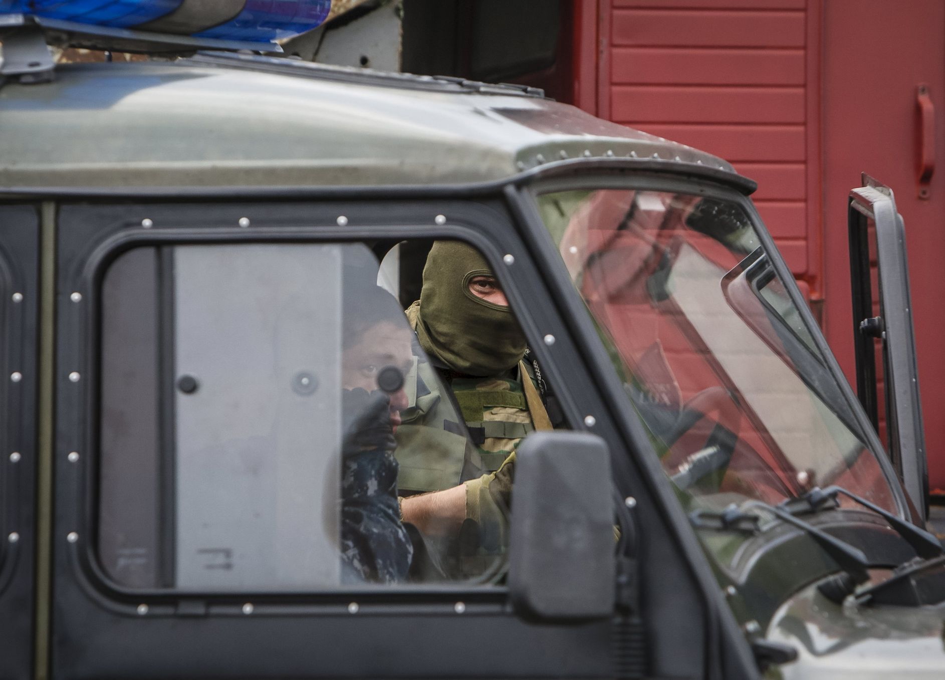 An interior ministry serviceman looks on as he stands at the scene of a shootout near Mukacheve