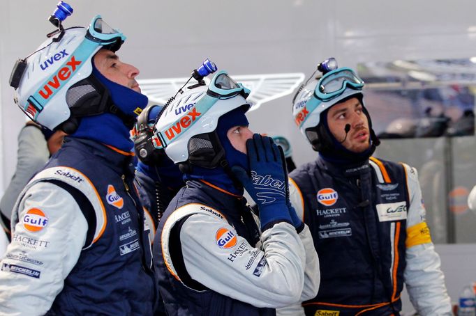 Crew members of the Aston Martin Vantage GTE Number 99 react after the crash and the withdrawal of their car during the Le Mans 24-hour sportscar race in Le Mans, central