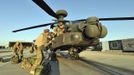 Britain's Prince Harry (C) carries out a pre-flight check to his Apache helicopter in Camp Bastion, southern Afghanistan in this photograph taken November 1, 2012, and released January 21, 2013. The Prince, who is serving as a pilot/gunner with 662 Squadron Army Air Corps, is on a posting to Afghanistan that runs from September 2012 to January 2013. Photograph taken November 1, 2012. Photograph pixelated at source. REUTERS/John Stillwell/Pool (AFGHANISTAN - Tags: MILITARY POLITICS SOCIETY ROYALS CONFLICT) Published: Led. 21, 2013, 8:01 odp.