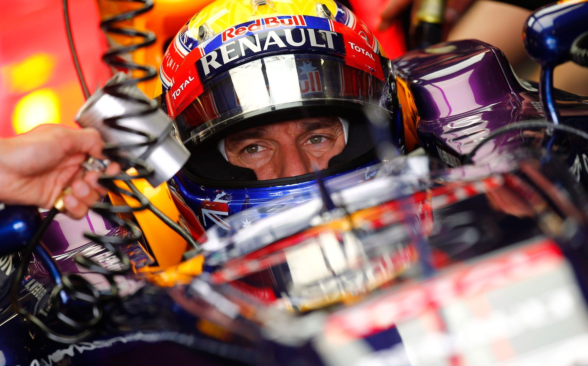 Red Bull Formula One driver Mark Webber waits in his car dur
