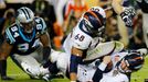 Denver Broncos' quarterback Peyton Manning is sacked by Carolina Panthers' Kony Ealy (94) as Broncos' Ryan Harris falls on Manning