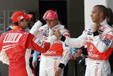 Felipe Massa ze stáje Ferrari (vlevo) si potřásá rukou s Lewisem Hamiltonem po kvalifikaci na VC Turecka, vzadu přihlíži druhý pilot McLarenu Heikki Kovalainen.
