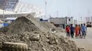 Olympic Park under construction in Sochi, Russia SOCHI, RUSSIA. MAY 20, 2013. Workers walk past piles of dirt at the construction site of Fisht Stadium and Olympic Park. In 2014 Sochi is set to host 2014 Winter Olympic Games.