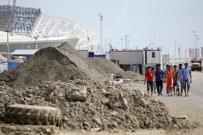 Olympic Park under construction in Sochi, Russia SOCHI, RUSSIA. MAY 20, 2013. Workers walk past piles of dirt at the construction site of Fisht Stadium and Olympic Park. In 2014 Sochi is set to host 2014 Winter Olympic Games.