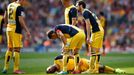 Atletico Madrid's Arda Turan lies on the pitch during their soccer match against Barcelona in Barcelona