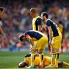 Atletico Madrid's Arda Turan lies on the pitch during their soccer match against Barcelona in Barcelona