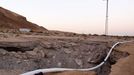 Israel, Dead Sea Damage caused by a sinkhole. The sinkholes are caused by the receding water level o