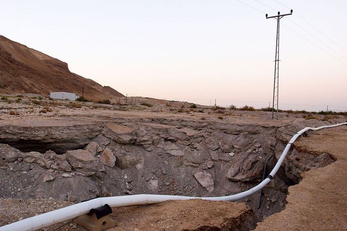 Israel, Dead Sea Damage caused by a sinkhole. The sinkholes are caused by the receding water level o