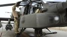 Britain's Prince Harry looks into the cockpit of an Apache helicopter in Camp Bastion, southern Afghanistan in this photograph taken October 31, 2012, and released January 21, 2013. The Prince, who is serving as a pilot/gunner with 662 Squadron Army Air Corps, is on a posting to Afghanistan that runs from September 2012 to January 2013. Photograph taken October 31, 2012. Photograph pixelated at source. REUTERS/John Stillwell/Pool (AFGHANISTAN - Tags: MILITARY POLITICS SOCIETY ROYALS CONFLICT) Published: Led. 21, 2013, 7:45 odp.