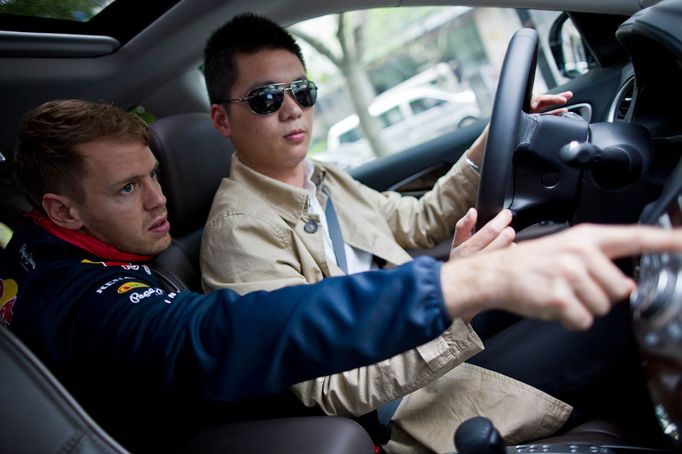 Red Bull Formula One driver Sebastian Vettel of Germany speaks to the driver during an interview with Reuters ahead of the Chinese F1 Grand Prix in Shanghai, April 16, 20