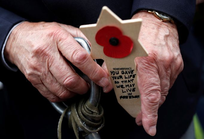 WWII D-Day veteran Mervyn Kersh from Britain holds a remembrance cross as he attends a ceremony at Normandy American Cemetery and Memorial situated above Omaha Beach