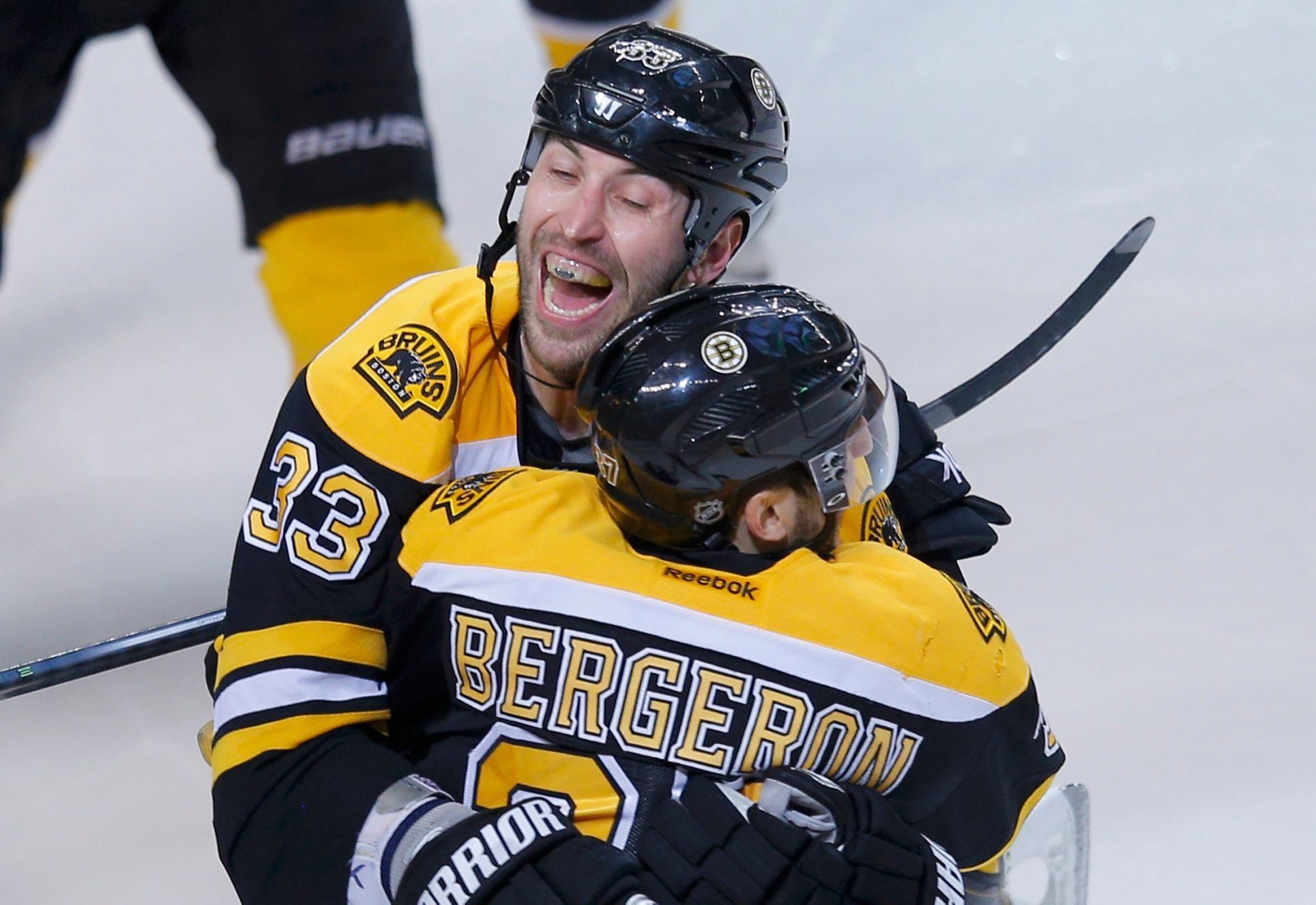 Bruins' Bergeron celebrates with teammate Chara after scorin