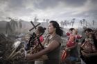 Francouzský fotograf Phillipe Lopez vyhrál první místo v kategorii Spot News Single za snímek přeživších tajfun Haiyan během náboženského procesí v Tolose na Filipínách.