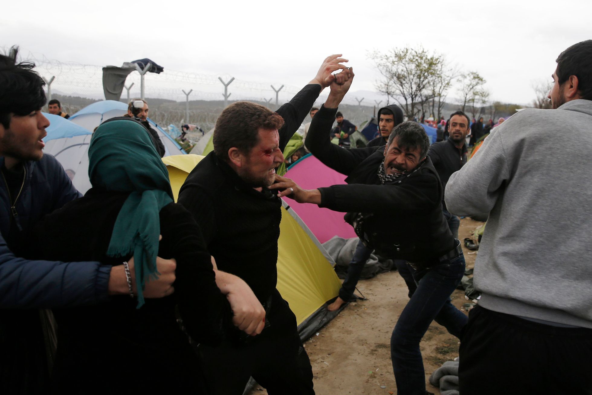 Migrants, who are waiting to cross the Greek-Macedonian border, fight between themselves at a makeshift camp near the village of Idomeni