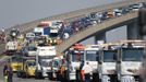 Recovery trucks line up to collect over 100 vehicles involved in multiple collisions, which took place in dense fog during the morning rush hour, on the Sheppey Bridge in Kent, east of London, September 5, 2013. Eight people were seriously injured and dozens hurt in the multiple crashes.