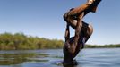 A Yawalapiti boy dips his head into the Xingu River in the Xingu National Park, Mato Grosso State, May 9, 2012. In August the Yawalapiti tribe will hold the Quarup, which is a ritual held over several days to honour in death a person of great importance to them. This year the Quarup will be honouring two people - a Yawalapiti Indian who they consider a great leader, and Darcy Ribeiro, a well-known author, anthropologist and politician known for focusing on the relationship between native peoples and education in Brazil. Picture taken May 9, 2012. REUTERS/Ueslei Marcelino (BRAZIL - Tags: ENVIRONMENT SOCIETY TPX IMAGES OF THE DAY) ATTENTION EDITORS - PICTURE 01 28 FOR PACKAGE 'LIFE WITH YAWALAPITI TRIBE' Published: Kvě. 15, 2012, 5:08 odp.