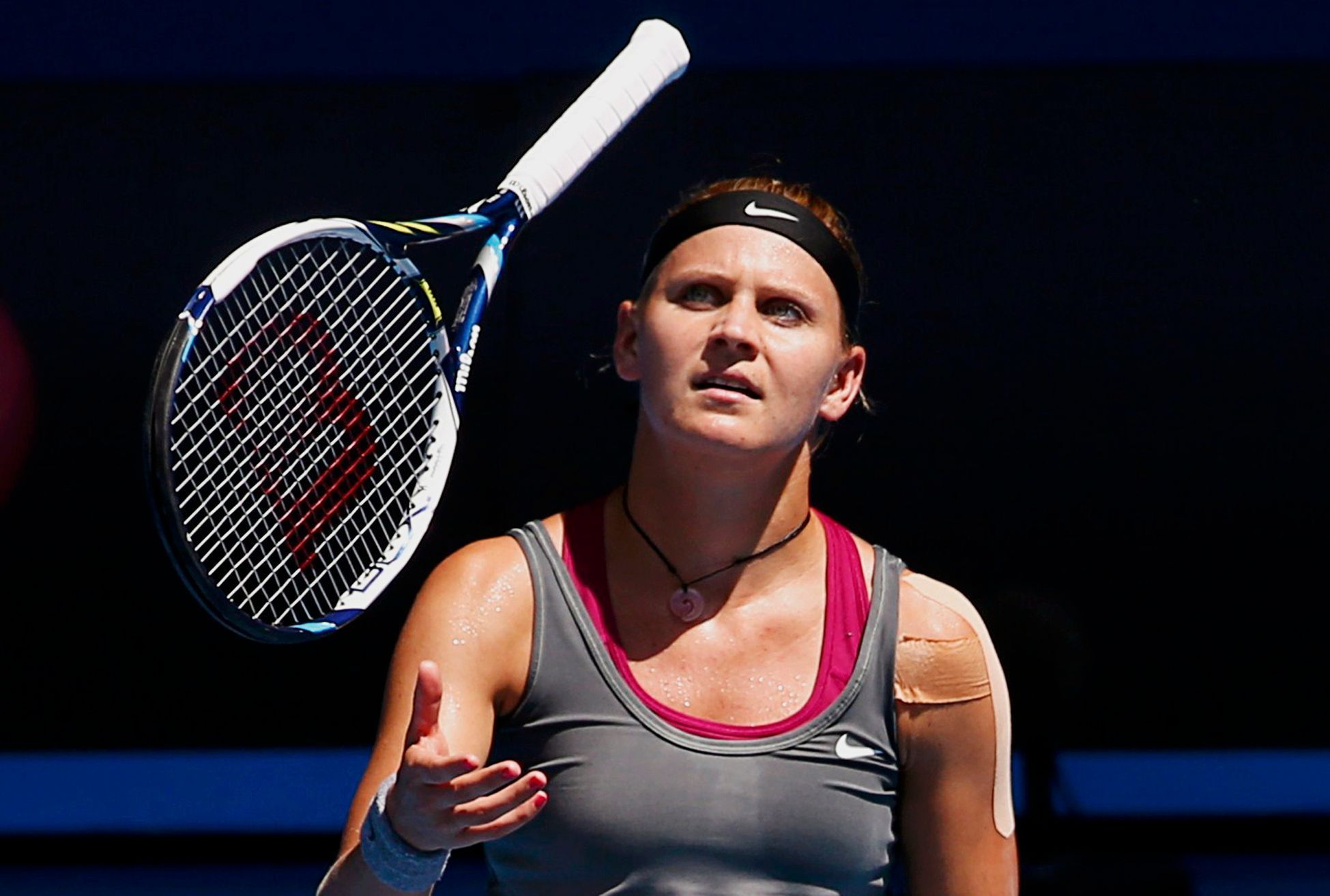 Lucie Safarova of the Czech Republic throws her racquet  up in the air during her women's singles match against Li Na of China at the Australian Open 2014 tennis tournament in Melbourne