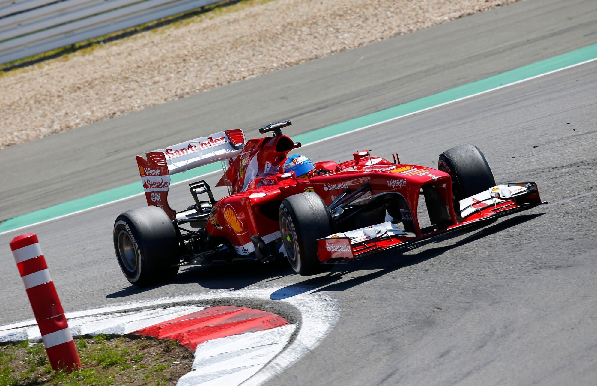 Ferrari Formula One driver Alonso takes corner during German