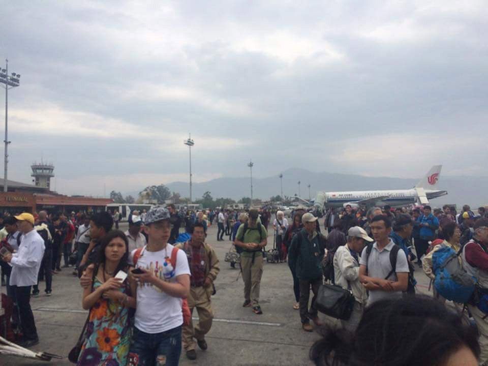 Handout shows people standing on the runway outside the International Terminal after a earthquake hit, at Tribhuvan International Airport, Kathmandu, Nepal