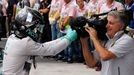 Mercedes Formula One driver Nico Rosberg of Germany jokes with the cameraman to celebrate as he steps out of his car after winning the Brazilian Grand Prix in Sao Paulo N