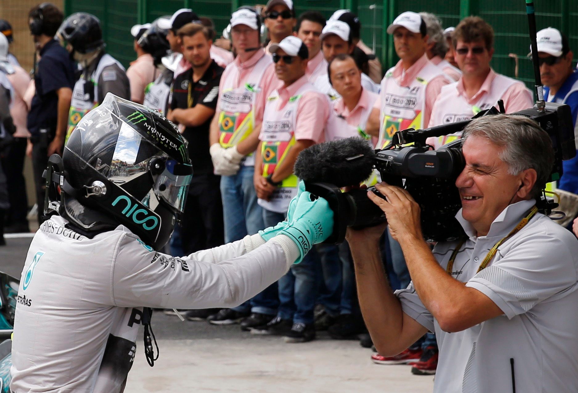 Mercedes Formula One driver Nico Rosberg of Germany jokes with the cameraman to celebrate as he steps out of his car after winning the Brazilian Grand Prix in Sao Paulo