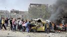 People and security personnel try to remove a car from an explosion site in Damascus May 10, 2012. Dozens of people were killed or wounded in two "terrorist explosions" which struck a southern district of the Syrian capital Damascus on Thursday, state television said. REUTERS/Sana/Handout (SYRIA - Tags: CIVIL UNREST POLITICS) FOR EDITORIAL USE ONLY. NOT FOR SALE FOR MARKETING OR ADVERTISING CAMPAIGNS. THIS IMAGE HAS BEEN SUPPLIED BY A THIRD PARTY. IT IS DISTRIBUTED, EXACTLY AS RECEIVED BY REUTERS, AS A SERVICE TO CLIENTS Published: Kvě. 10, 2012, 7:20 dop.