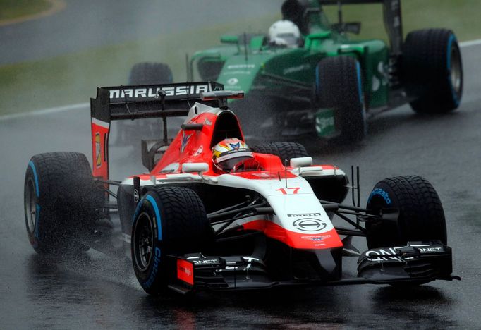 Marussia Formula One driver Jules Bianchi of France drives in front of Caterham Formula One driver Kamui Kobayashi of Japan during the Japanese F1 Grand Prix at the Suzuk