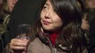 A woman holds a wine glass as she attends the official launch of the 2012 Beaujolais Nouveau wine in the center of Lyon early November 15, 2012. REUTERS/Robert Pratta (FRANCE - Tags: SOCIETY) Published: Lis. 15, 2012, 2:25 dop.