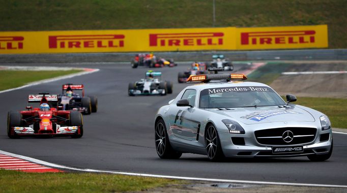 Ferrari Formula One driver Fernando Alonso of Spain (L) follows a safety car during the Hungarian F1 Grand Prix at the Hungaroring circuit, near Budapest July 27, 2014. R