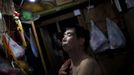 Xiao Cao, a 57-year-old gay man, prepares to dress after taking a shower at his home in Shanghai April 8, 2012. China's gay community has long been on the edges of society but it is gradually becoming more accepted. Cao, who is an unemployed drag queen, is one whose life lifts the curtain on a less romanticised view of Chinese homosexuals. Living in an eight square metres apartment behind a public toilet and with a monthly income of 500 yuan ($79) from social insurance, he passes his days dancing in public and spending time with friends at gay clubs. Picture taken April 8, 2012. REUTERS/Aly Song (CHINA - Tags: SOCIETY) CHINA OUT. NO COMMERCIAL OR EDITORIAL SALES IN CHINA. ATTENTION EDITORS PICTURE 03 OF 28 OF PACKAGE 'GAY AND OUT IN CHINA' TO FIND ALL IMAGES SEARCH 'GAY OUT CHINA' Published: Čer. 1, 2012, 12:33 dop.