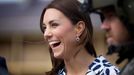 Catherine, Duchess of Cambridge, laughs as she puts on earplugs as they prepare to board a Royal Australian Navy MRH90 helicopter at Sydney's Victoria Barracks