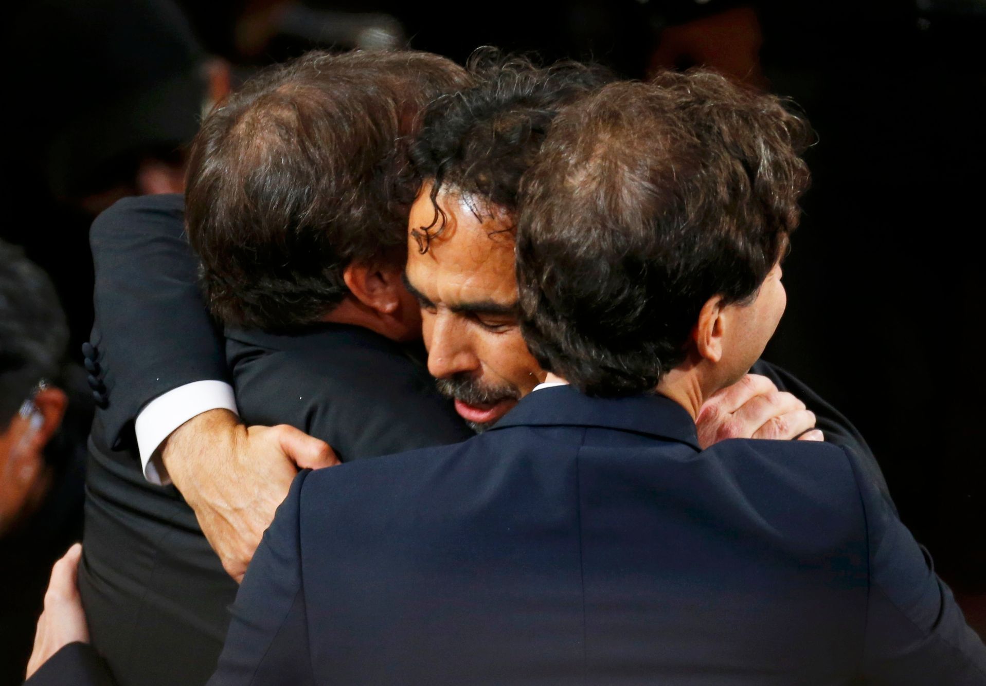 Director Inarritu is embraced as he walks to accept the Oscar for best director at the 87th Academy Awards in Hollywood