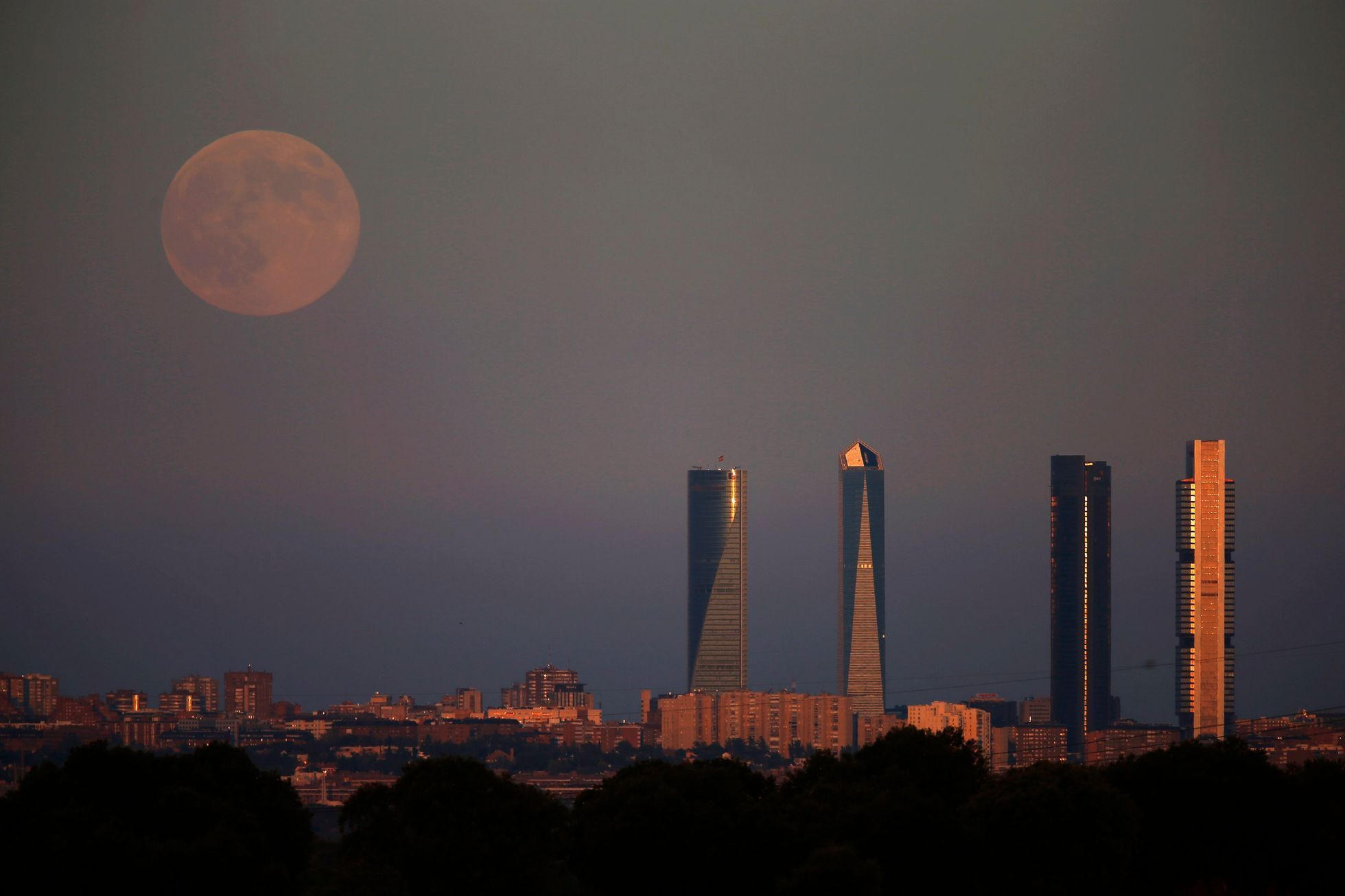 The Supermoon rises over the Four Towers Business Area in Madrid