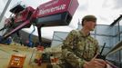 A soldier looks out from a vantage point near an entrance to the London 2012 Olympic Park at Stratford in London July 12, 2012. Britain could be forced to deploy thousands of extra troops in London during the Olympics after a last-minute security blunder dealt an embarrassing blow to the government just two weeks before the Games. REUTERS/Luke MacGregor (BRITAIN - Tags: SPORT OLYMPICS MILITARY) Published: Čec. 12, 2012, 4:52 odp.