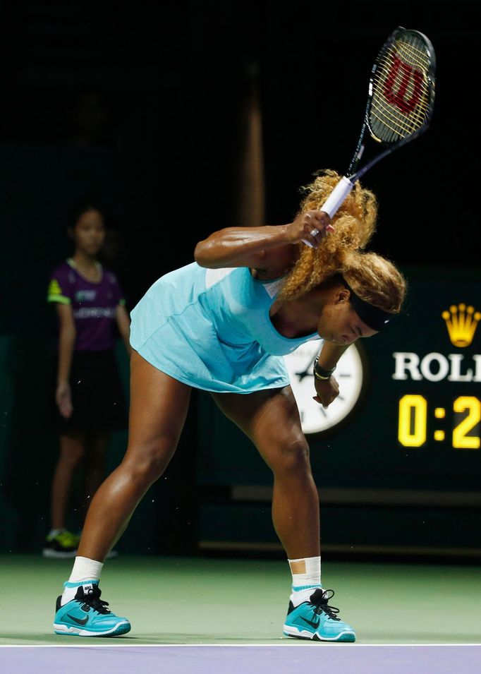 Serena Williams of the U.S. smashes her second racquet during her WTA Finals singles semi-finals tennis match against Caroline Wozniacki of Denmark at the Singapore Indoo