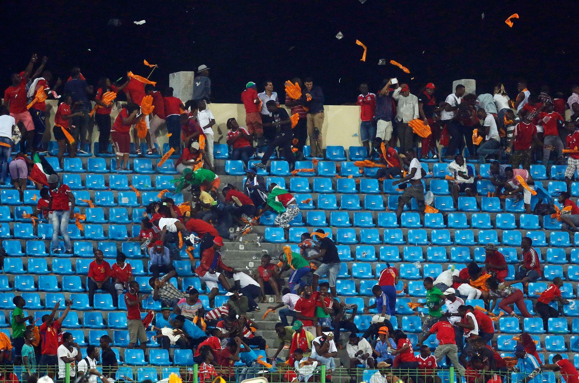 Equitorial Guinea fans react as a police helicopter hovers above the stand during the African Cup semi-final match against Ghana in Malabo