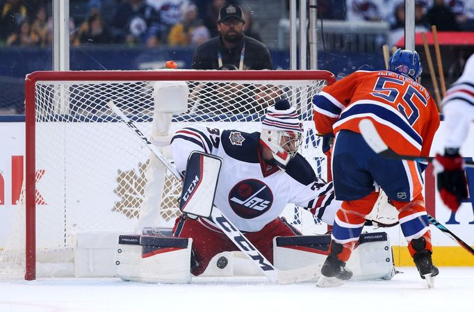 Connor Hellebuyck zasahuje proti střele Marka Letestua.