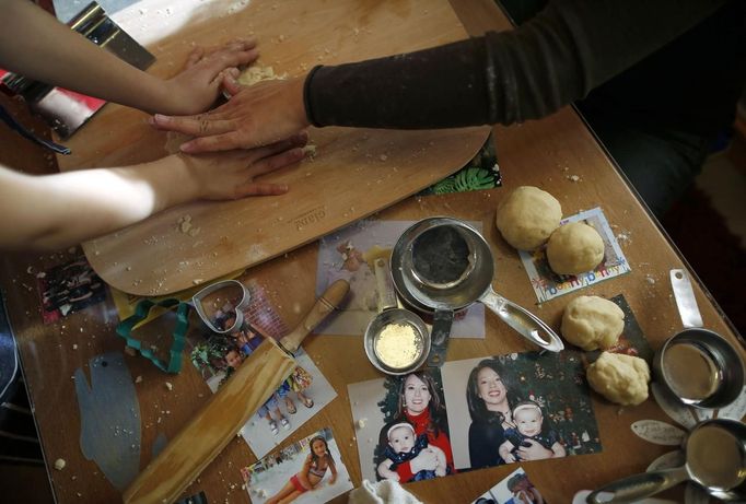 Mercedes Santos helps her daughter Ava make cookies at their home in Chicago, Illinois, December 22, 2012. Santos and her partner Theresa Volpe are a same-sex couple raising two of their biological children as they struggle to get same-sex marriages passed into law in Illinois. Picture taken December 22, 2012. REUTERS/Jim Young (UNITED STATES - Tags: SOCIETY) Published: Bře. 25, 2013, 6:07 odp.