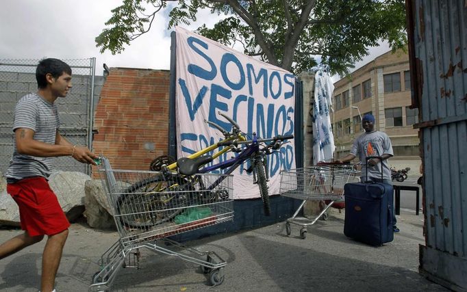 A squatter pushes a trolley at the entrance of an industrial building in the Poble Nou neighbourhood of Barcelona July 16, 2012. The squatters said that a police order to evict them from a complex was postponed by a judge on Monday. REUTERS/Albert Gea (SPAIN - Tags: REAL ESTATE BUSINESS SOCIETY POVERTY) Published: Čec. 16, 2012, 4:56 odp.