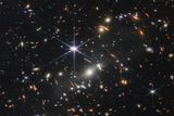 První snímek z teleskopu Jamese Webba zveřejnila NASA v červenci. Zachycuje část vesmíru označovaného jako SMACS 0723, který je od Země pět miliard světelných let. Jsou na něm galaxie různého stáří a každá obsahuje stovky miliard hvězd. Fotografie také odhaluje, jak oblast vypadala před 13 miliardami let, tedy nedlouho po velkém třesku. "Vracíme se téměř na začátek," uvedl ředitel NASA Bill Nelson s tím, že jde o "nejhlubší pohled do vesmíru, jaký kdy byl pořízen".